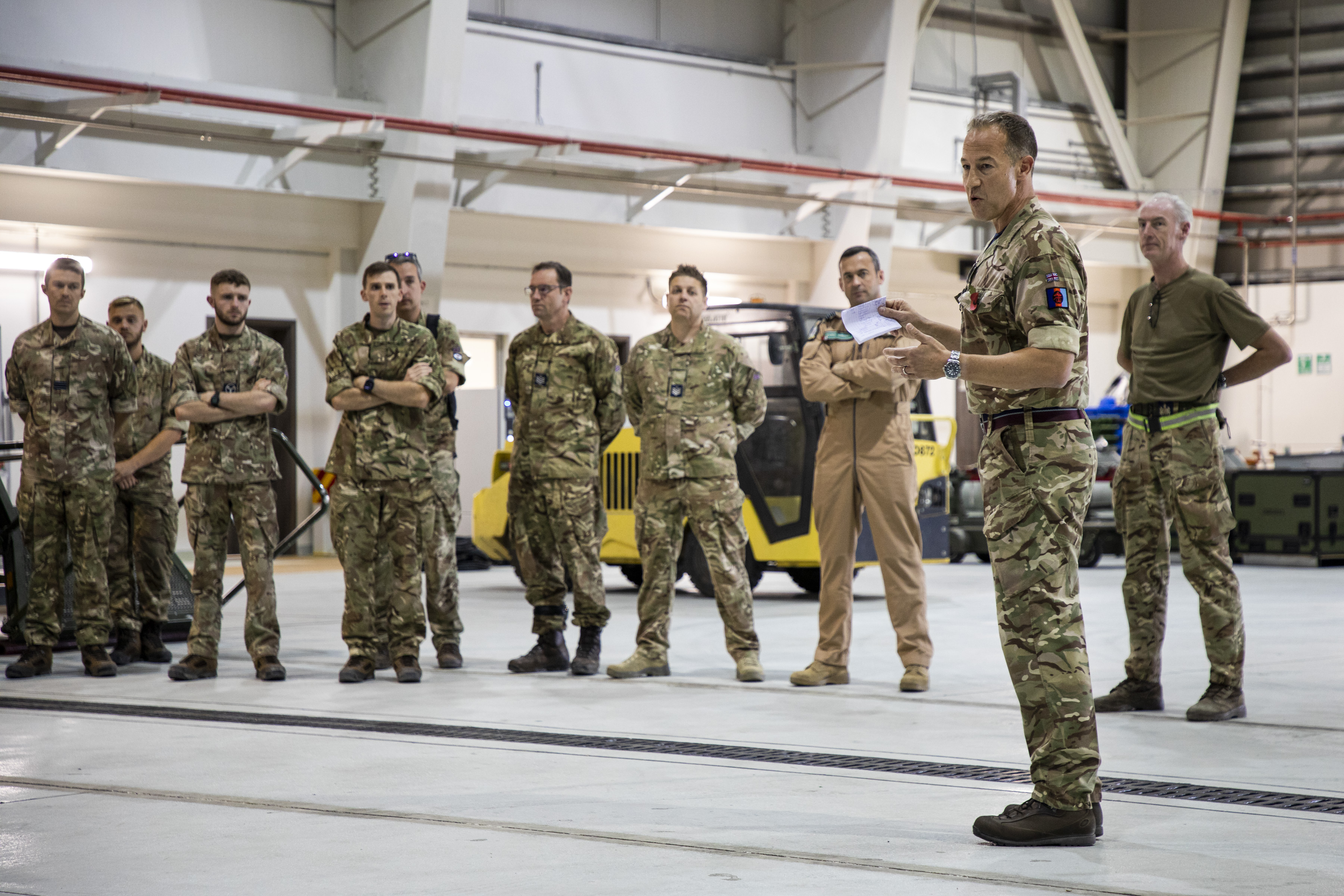 Image shows RAF aviators standing in discussion.